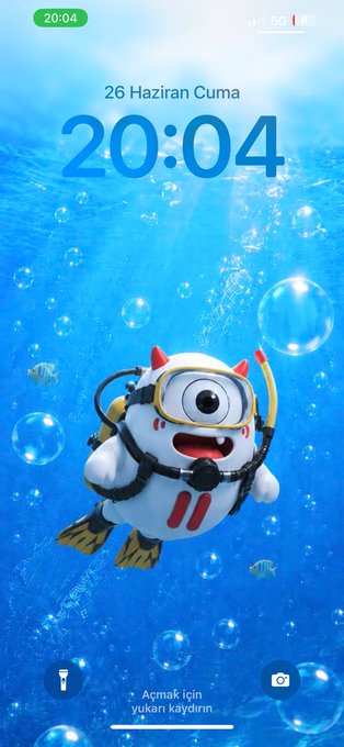 A phone lock screen displays the time "20:04" on Friday, June 26th ("26 Haziran Cuma"), featuring a 3D-rendered cartoon bull character in scuba gear floating in a blue underwater scene with bubbles and tropical fish, matching the post's description of the new 3D TRON Bull wallpaper design.