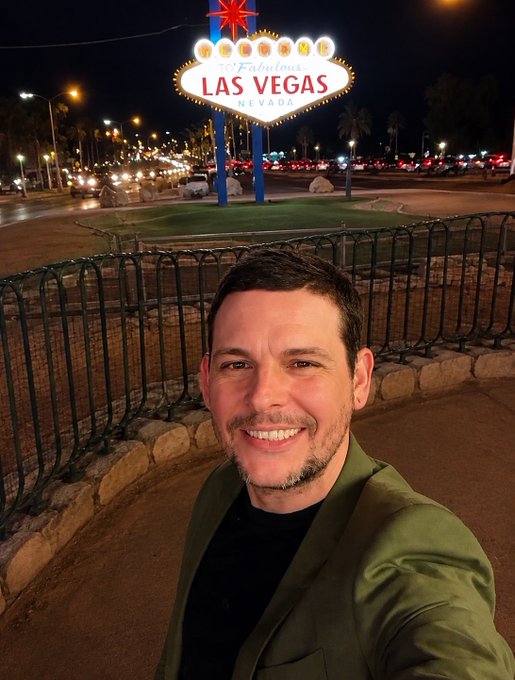 A man takes a selfie in front of the iconic "Welcome to Fabulous Las Vegas, Nevada" sign at night, likely during a recent visit to Vegas. The post references a personal update about his profile picture change, suggesting the image marks a new chapter as he steps back from crypto to attend to a family matter.