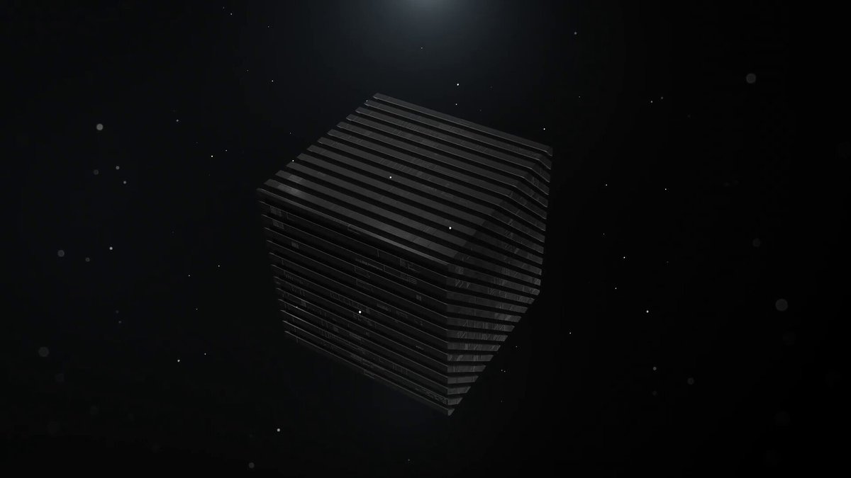 The image shows a black cube floating in space against a dark background, surrounded by numerous small white particles. The cube appears to be floating in the void of outer space, with no visible text or additional objects present.