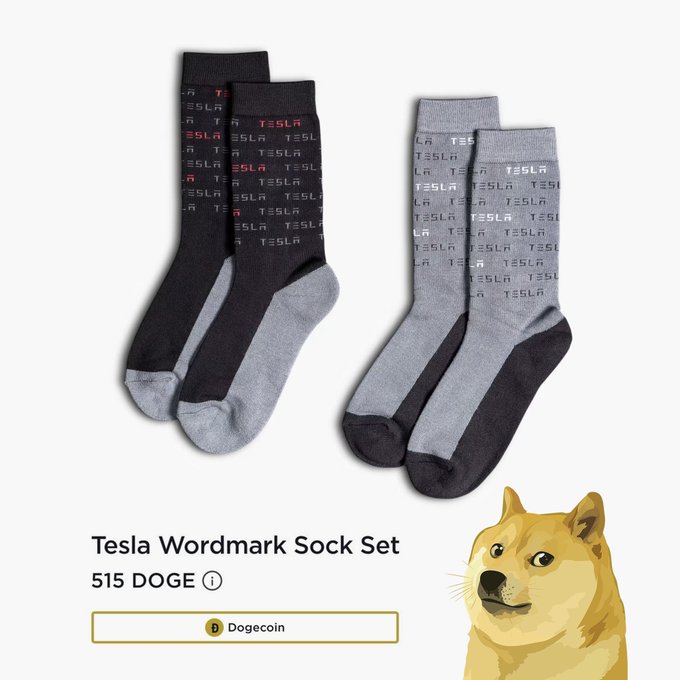A product-style image shows a “Tesla Wordmark Sock Set” priced at “515 DOGE,” with the Dogecoin ticker “Dogecoin” below and a Shiba Inu/Dogecoin illustration at the bottom. The Tesla-themed socks and wording humorously support the post’s message that people can make @Tesla more entertaining “right right now,” tagged with @elonmusk.