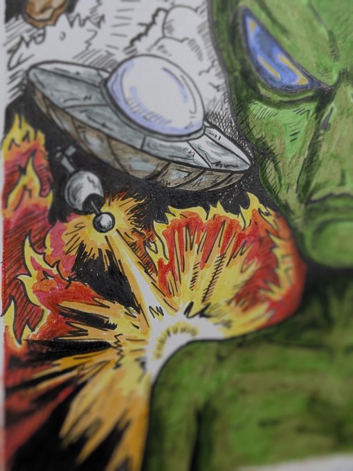A colorful comic-book style illustration showing a silver UFO beam and an explosion of fire near a green alien's face.