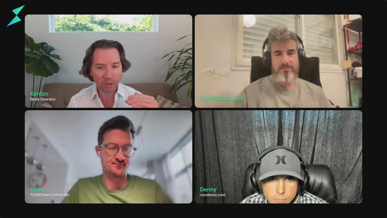 The image shows four men sitting at a table, each wearing headphones and looking at their computer screens. The screens display different versions of themselves, possibly from a video conference or online meeting. The men are all facing the same direction towards the camera, creating an interesting visual effect as they appear to be in a group discussion or collaborative project.