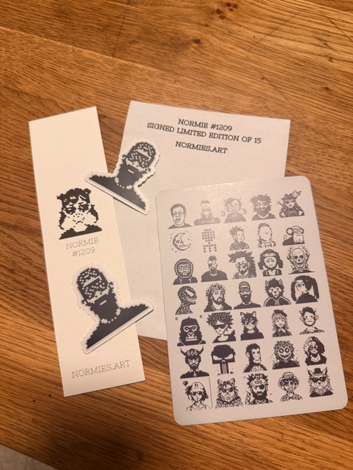 A limited edition package of 'NORMIB #1209' signed art stickers from 'NORMIES.ART', showing pixel-art character stickers alongside a backing card.