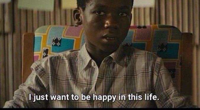 A young boy sits in a chair with the subtitle reading, "I just want to be happy in this life."