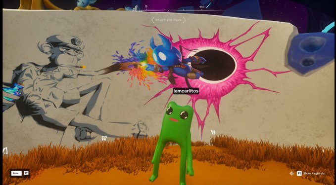 The image features a cartoon frog standing next to a wall with a large pink explosion coming out of it, along with some text that reads "Just a Frog contemplating creation on the @OthersideMeta". The frog appears to be looking at the explosion in awe or curiosity.