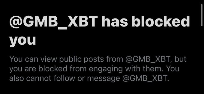A screenshot of an X (Twitter) notification reading "@GMB_XBT has blocked you," explaining that while you can view public posts from @GMB_XBT, you cannot engage, follow, or message them. The irony of the "based GMB WEB3DEGENMAXI" caption is that the poster has apparently been blocked by the very account they are praising.