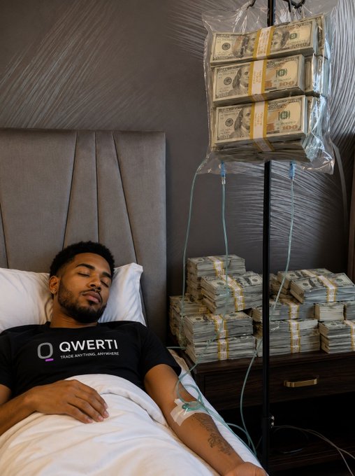 A young man wearing a black 'QWERTI - Trade Anything, Anywhere' t-shirt lies in bed with an IV drip, surrounded by large plastic bags of US dollar bills suspended from an IV stand, with stacks of cash on the nightstand.