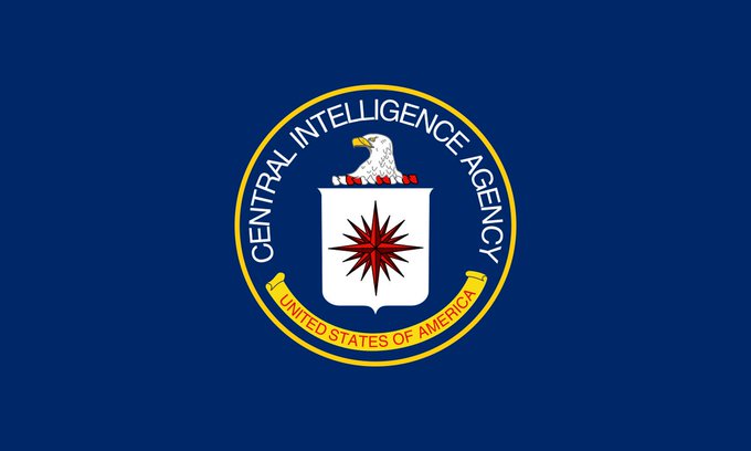 The image features a blue circular emblem with a white eagle, which appears to be the logo of the Central Intelligence Agency (CIA). The CIA logo is prominently displayed at the center of the image against a dark background. Below the CIA logo, there's a red star that reads "Ripple" in white letters. This text is related to the post because it mentions Ripple as the new petrodollar system taking shape.