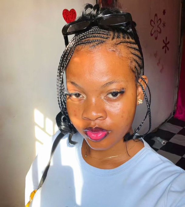 A young woman with sleek cornrow braids and sunglasses perched on her head poses in bright natural light, projecting confident energy that mirrors the bullish, optimistic vibe of "GM Web3 — We are winning today."