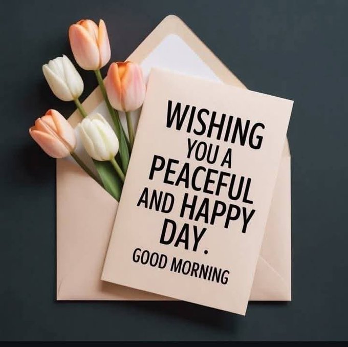 The image features an envelope containing a card that reads "Wishing you a peaceful and happy day" along with some flowers inside. The flowers are pink and white tulips, which are arranged neatly within the envelope. The background of the image is black, providing a stark contrast to the colorful elements in the foreground.