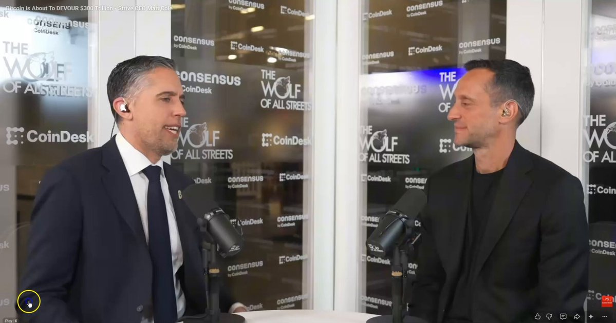 The image shows a man wearing a suit talking to another man, both standing behind microphones. They appear to be discussing Bitcoin or cryptocurrency, as indicated by the text "@STRIVE CEO @COLEMACRO ON BITCOIN: Bitcoin is either a Ponzi scheme going to zero or it'll probably land somewhere reasonable." The post seems to be promoting Bitcoin and making bold claims about its future value.