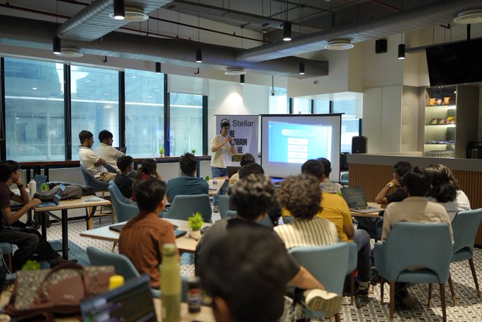 The post was cut off, so here's a concise caption based on what's visible:

A speaker from Stellar presents at the Stellar Build Station Kolkata event, hosted by Rise In, with the Stellar logo displayed on screen as a seated audience listens and takes notes.

The image directly illustrates the post, showing the speaker delivering his talk about Hypertron to an engaged audience at the Stellar Build Station event.