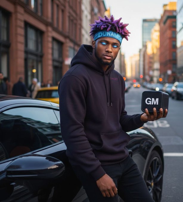 A young man with purple spiky hair, glowing blue eyes, and a blue headband reading 'DUNAMIX' stands on a city street next to a black sports car while holding a black box labeled 'GM'.