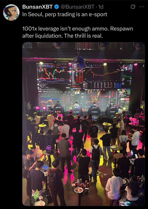 The image shows a social media post featuring a large crowd of people gathered around a TV screen displaying stock market data, with the text "100X leverage isn't enough after liquidation. The thrill is real". A person from BunanXBT, a trading platform, has also shared this content on their Twitter account. It appears that BunanXBT and a new player called "@SpeculateTrade" are promoting their respective e-sports tournaments with the aim of attracting more participants to their platforms by leveraging the excitement of the stock market data.