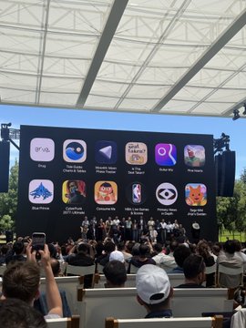 The image shows a large screen displaying various app icons, including popular apps like Instagram, Pokemon Go, and others. A group of people are gathered around the screen, with some sitting on chairs and others standing. The crowd appears engaged and interested in the displayed apps. The caption "Congrats on the ADA winners" is present in the image, suggesting that this event might be related to an accomplishment or achievement by someone with a disability.