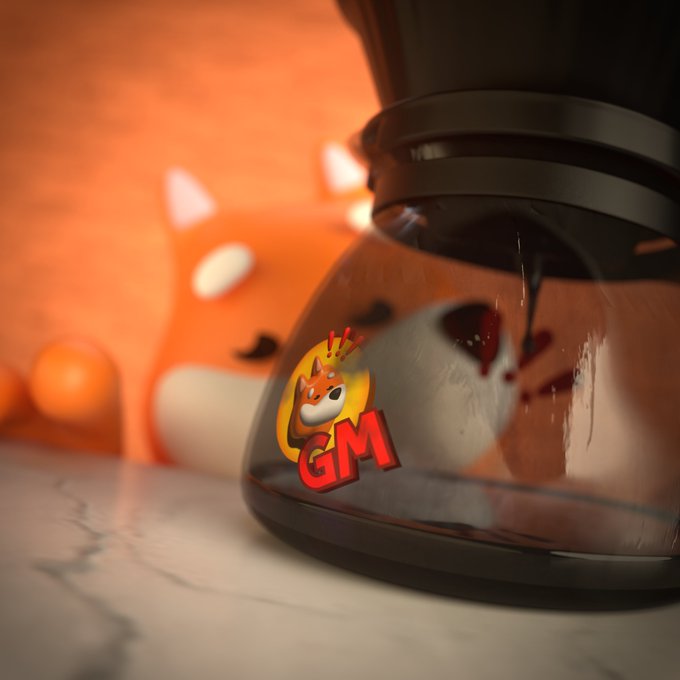 The image features a black coffee maker with a red sticker that reads "GM", along with an orange cartoon character design on top of the coffee maker.
