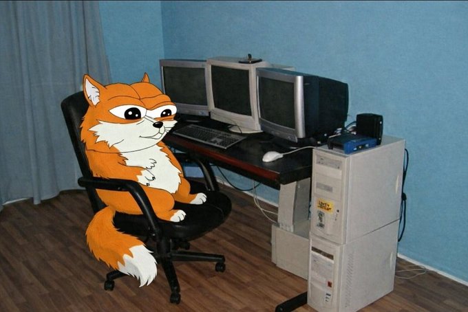 An illustration of a chubby orange and white fox sitting in a black office chair in front of a desk with multiple computer monitors and a tower PC.