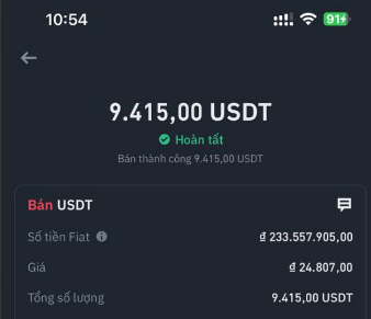 A mobile app screenshot in Vietnamese showing a successful transaction of 'Bán thành công 9.415,00 USDT' with a price of 24.807,00.