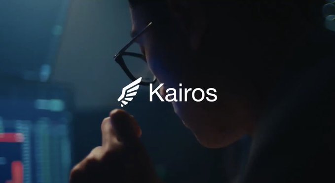 A dimly lit scene of a person wearing glasses viewed in profile, with the 'Kairos' logo (a winged emblem) overlaid in the center.