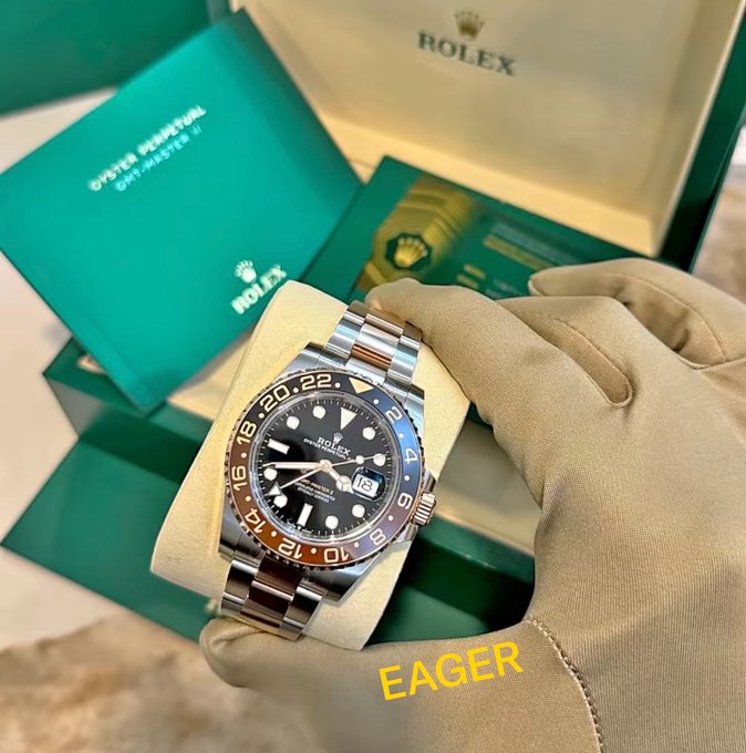 A gloved hand holds a Rolex GMT-Master II watch with a black and brown "Rootbeer" bezel, displayed alongside its green Rolex box and paperwork labeled "Oyster Perpetual GMT-Master II." The image visually represents the watch-flipping asset strategy described in the caption, showcasing a high-end luxury timepiece as a tangible example of trading in collectibles for profit.