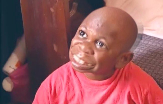 A smiling child with a shaved head wearing a red shirt is pictured, his expression conveying genuine happiness. The caption relates to the post by humorously depicting the child as the "token" that was sold cheaply at $2k, capturing that eager, hopeful face of someone holding an investment they believe will skyrocket in value.