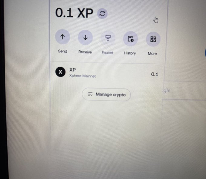 A close-up photo of a computer screen displays a cryptocurrency wallet showing a balance of "0.1 XP" on the "Xphere Mainnet," illustrating the poster's disappointment at receiving only a tiny airdrop allocation. The wallet interface includes options for Send, Receive, Faucet, History, and More, along with a "Manage crypto" button.