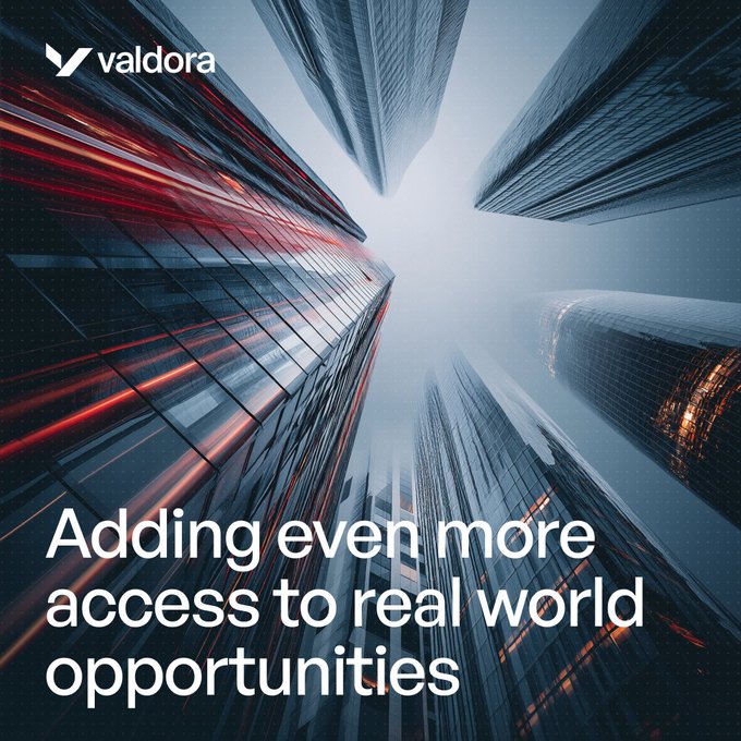 Valdora promotional banner with the headline 'Adding even more access to real world opportunities' displayed over an upward view of skyscrapers.