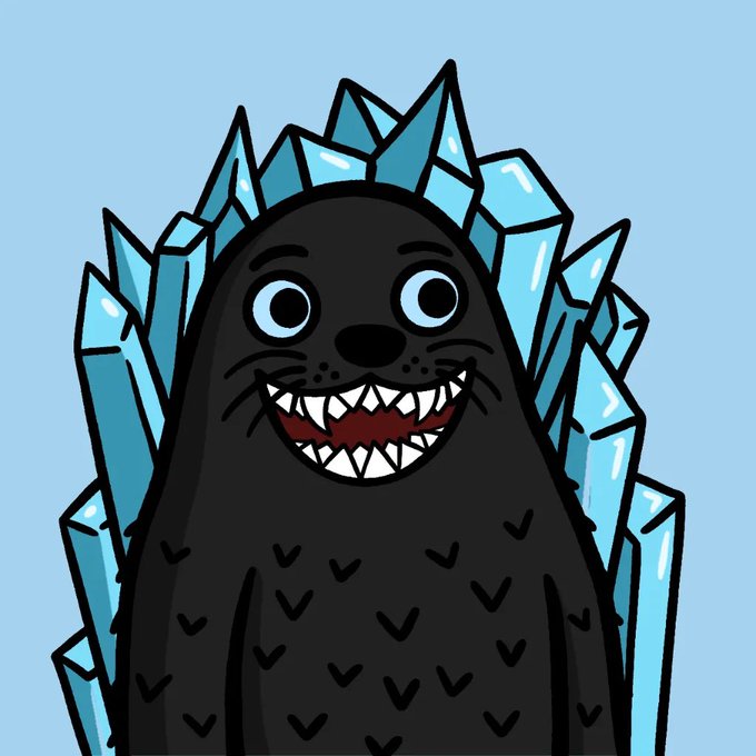 A cartoon illustration of a black seal-like creature with a wide sharp-toothed grin and big eyes, surrounded by light blue ice crystals against a pale blue background.