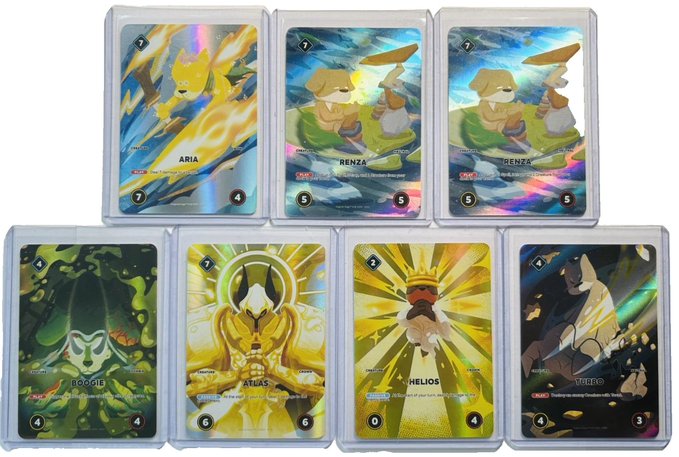 Seven holographic trading cards featuring animal characters, including ARIA (cat), two RENZA cards (dogs), BOGGIE, ATLAS, HELIOS, and TUDOR, with various stats and 'A' rarity markings.
