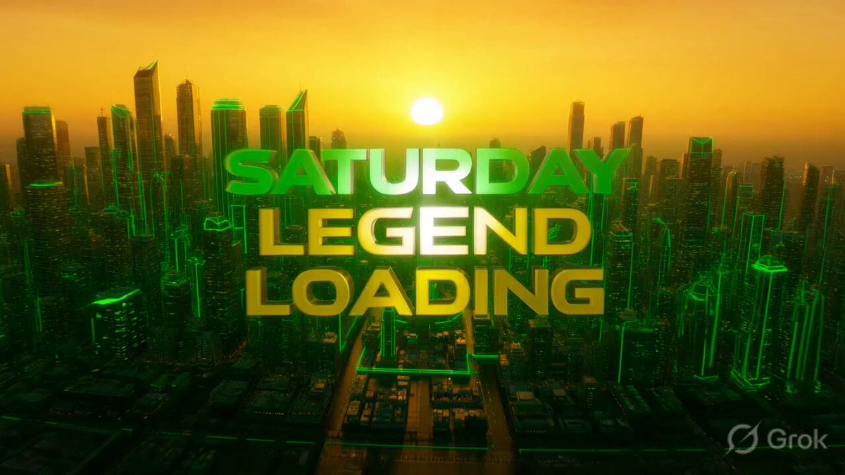 The image features a city skyline at sunset, with the words "Saturday Legend Loading" written above it in green letters. The sun is setting behind the buildings, creating a warm glow over the scene. The text appears to be part of an advertisement or promotional material for a game or streaming platform that uses the city skyline as its backdrop and incorporates the phrase "SATURDAY Legend Loading".