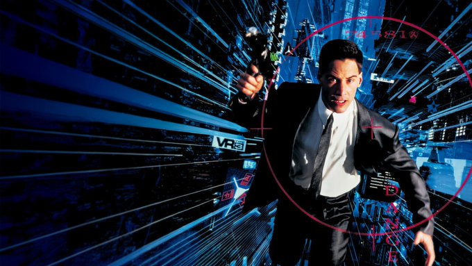 Keanu Reeves, reprising his iconic role from "Johnny Mnemonic" (1995), reaches through a cyberpunk data interface while uploading massive amounts of information — perfectly capturing the poster's joke about frantically downloading every open-weight AI model (Qwen, Llama, Mistral, DeepSeek) as a 900GB torrent before the guardrails arrive.