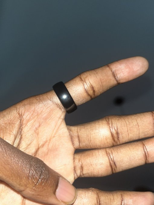 A hand displays a simple black ring on the index finger, symbolizing biometric self-custody as a natural, always-present solution to the flaws of passwords, paper, and devices in crypto wallet security.