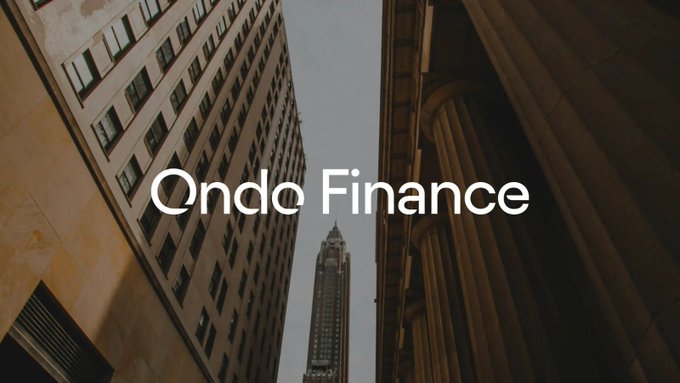 The image shows the "Ondo Finance" logo/text overlaid on a low-angle view of skyscrapers framing a central tower, symbolizing the company's reported pursuit of an acquisition in the $250 million to $500 million range as it expands beyond tokenized assets. The imposing urban architecture visually reinforces the significant scale of the potential deal described in the accompanying post.