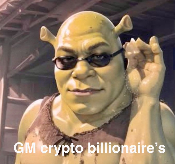 A meme image of Shrek wearing sunglasses, adjusting them with one hand, with text overlay 'GM crypto billionaire's'.