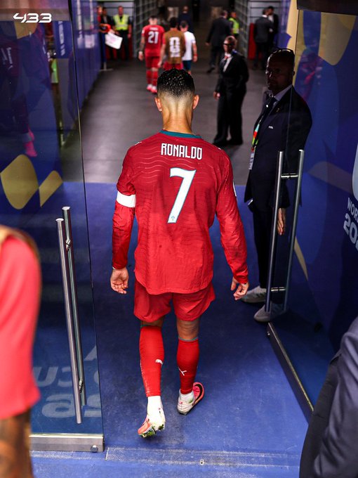 Cristiano Ronaldo, wearing the number 7 Portugal jersey, walks down a stadium tunnel before a match, with a '433' logo visible in the corner.
