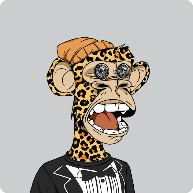 The image features a cartoon monkey wearing a suit, tie, and hat with leopard print accents. The monkey appears to be smiling and has its mouth open wide as if it's speaking or laughing. The background of the image is gray, which contrasts with the vibrant colors of the monkey's outfit. There are no other objects in the image besides the monkey itself.