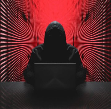 A hooded figure works on a laptop against a dramatic red digital background, symbolizing the cybersecurity threats driving new EU crypto wallet regulations.

The post's text is not visible in the image itself.