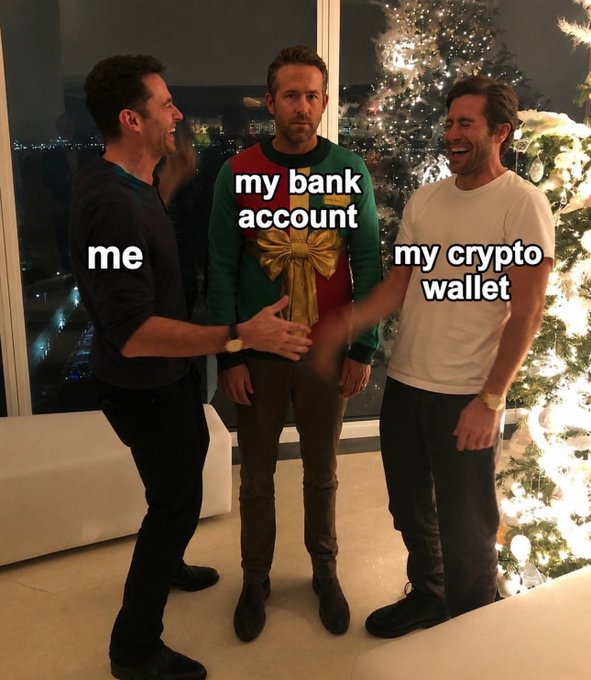 A meme featuring three men with the labels 'me' (left, laughing), 'my bank account' (center, in a Christmas sweater), and 'my crypto wallet' (right, laughing), set in a room with a Christmas tree in the background.