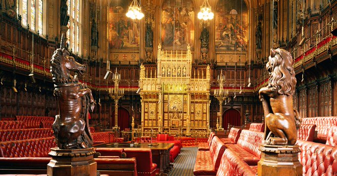 The image shows the ornate interior of the UK House of Lords, featuring red leather benches, gilded woodwork, and prominent unicorn and lion statues flanking the throne area. This setting directly relates to the post, as it depicts the very chamber where peers voted 194-138 in favor of Amendment 88 to the Financial Services and Markets Bill, which mandates a digital assets strategy for the Treasury.