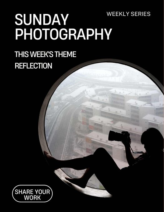 A silhouette of a photographer sits inside a large circular window, holding a camera while capturing a cityscape view, fitting this week's "Sunday Photography" theme of REFLECTION as promoted in the #TezosTuesday series, which invites creators to share their work.
