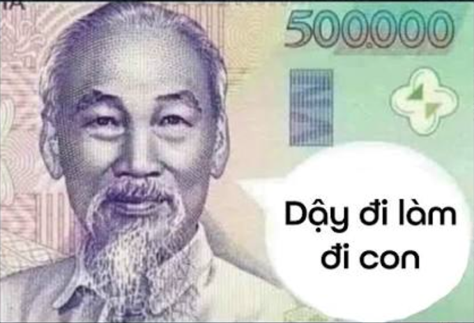 A Vietnamese 500,000 dong banknote featuring Ho Chi Minh, with a speech bubble overlaid containing the Vietnamese text "Dậy đi làm đi con".