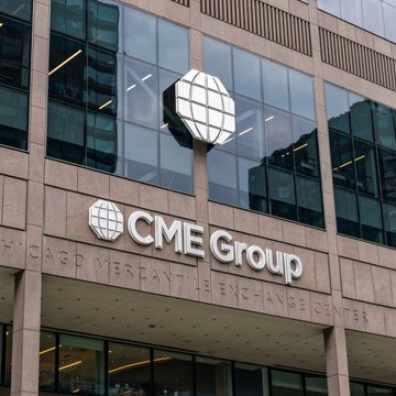 The exterior of a CME Group building features the globe logo and signage reading “CME Group” and “CHICAGO MERCANTILE EXCHANGE.”