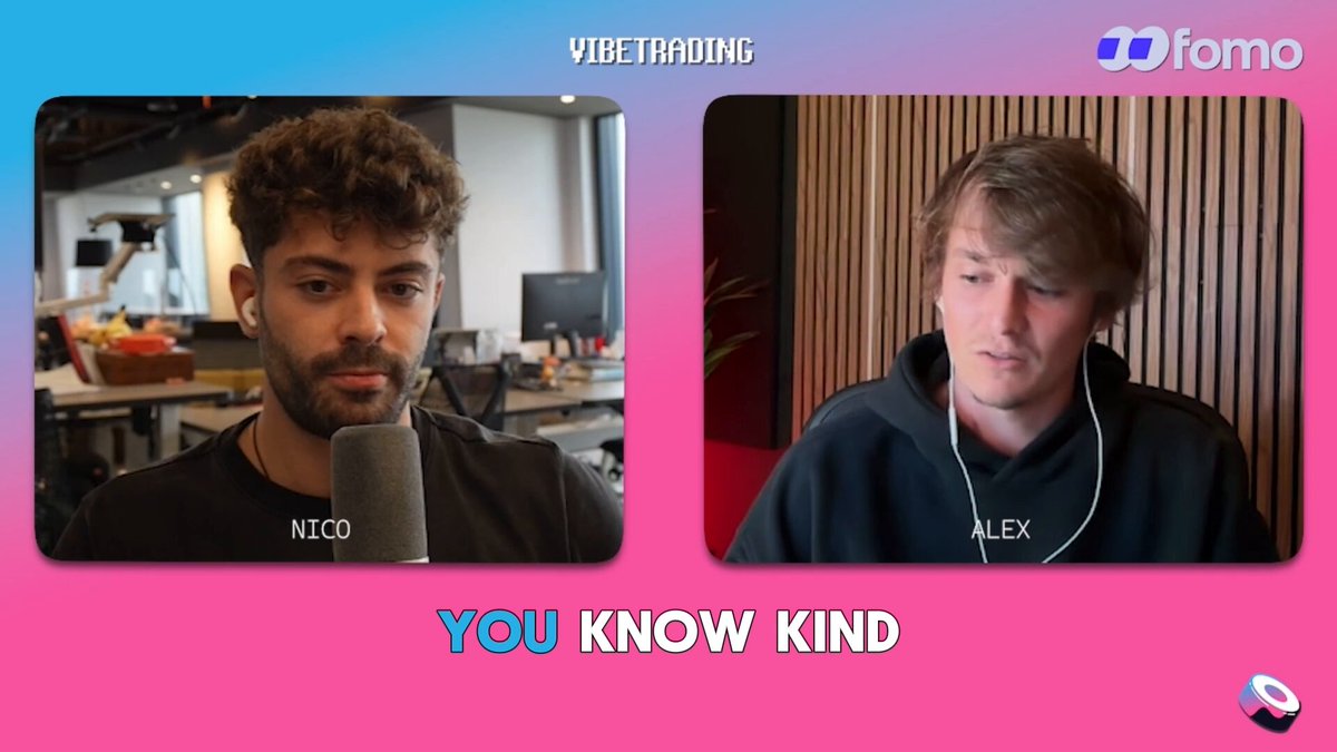 The image features two men sitting behind microphones, with one man wearing headphones and talking into them while the other man looks at him. They are both wearing black shirts. The background of the image shows a pink wall with a white logo that reads "FOMO".