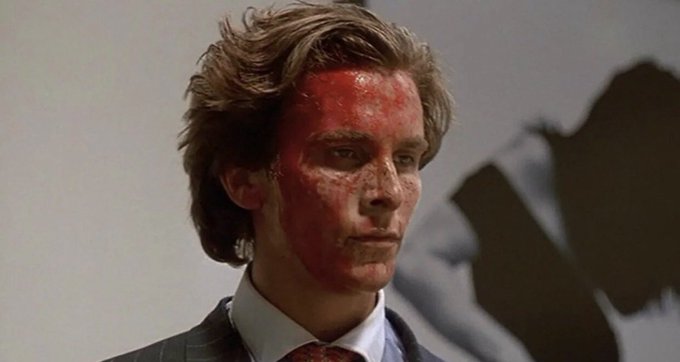 This is a still from the movie *American Psycho*, depicting Patrick Bateman with blood on his face, representing the immense and possibly violent "pump" in market cap mentioned in the post.