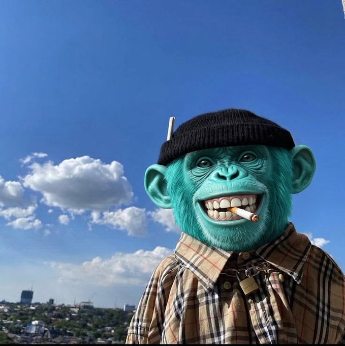 A blue-green monkey head figurine or character wearing a black beanie and a Burberry-style plaid shirt, with a cigarette in its mouth, photographed against a blue sky with clouds.