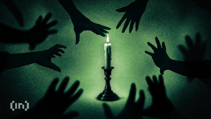 A dark image of silhouetted hands reaching toward a single lit candle, with an '[in]' logo in the bottom left corner.