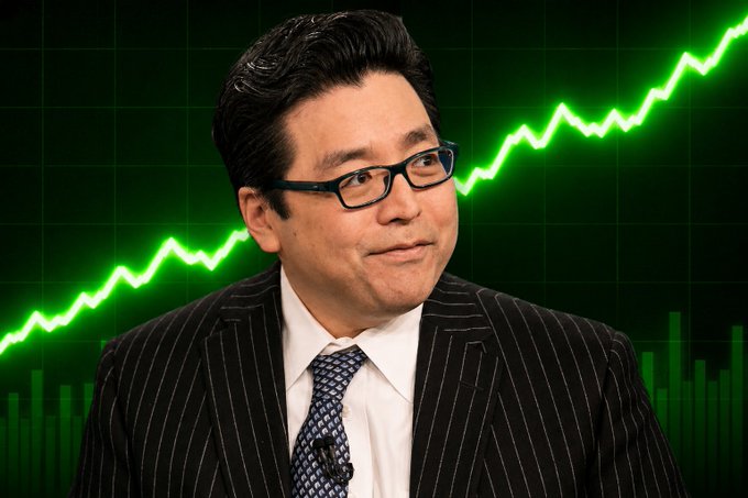 A man in a pinstripe suit and glasses appears against a green background featuring an upward-trending stock chart with a glowing line graph.