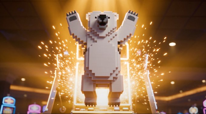 A large, pixelated polar bear statue stands with arms raised in a triumphant pose, surrounded by bright sparks and golden light in what appears to be a gaming venue.