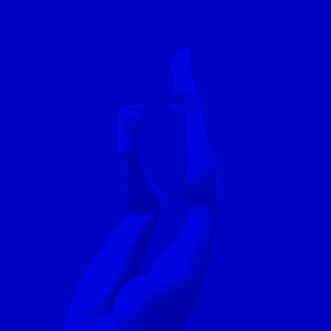 An artistic, monochromatic blue image showing a pair of legs extending upward from below the frame.