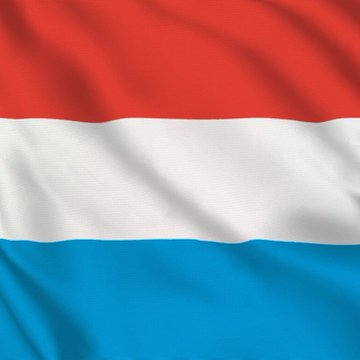 The flag of Luxembourg, featuring its distinctive horizontal red, white, and light blue stripes, is displayed waving against a dark background. The image accompanies a sensationalized social media post falsely claiming Luxembourg allocated sovereign wealth fund money to Bitcoin, using the national flag as visual context to lend credibility to the unverified financial news.